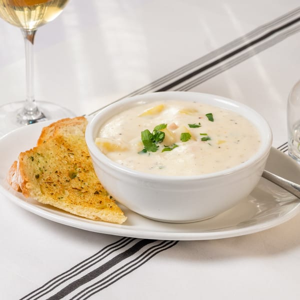 Creamy clam chowder with fresh parsley, served with garlic toast and white wine at Water Street Grill.